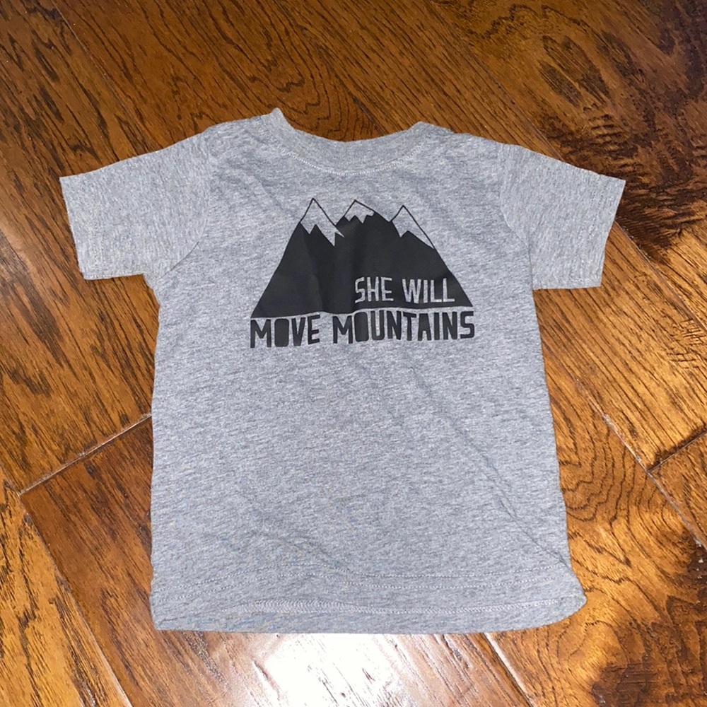 She will move mountains. Size 2 grey t shirt